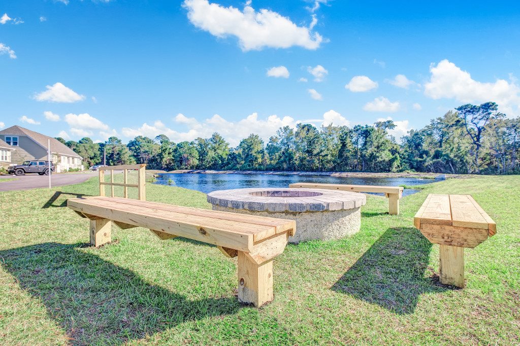 Apartments in Wilmington, NC - Myrtle Landing Outdoor Fire Pit with Bench Seating Overlooking Water Feature